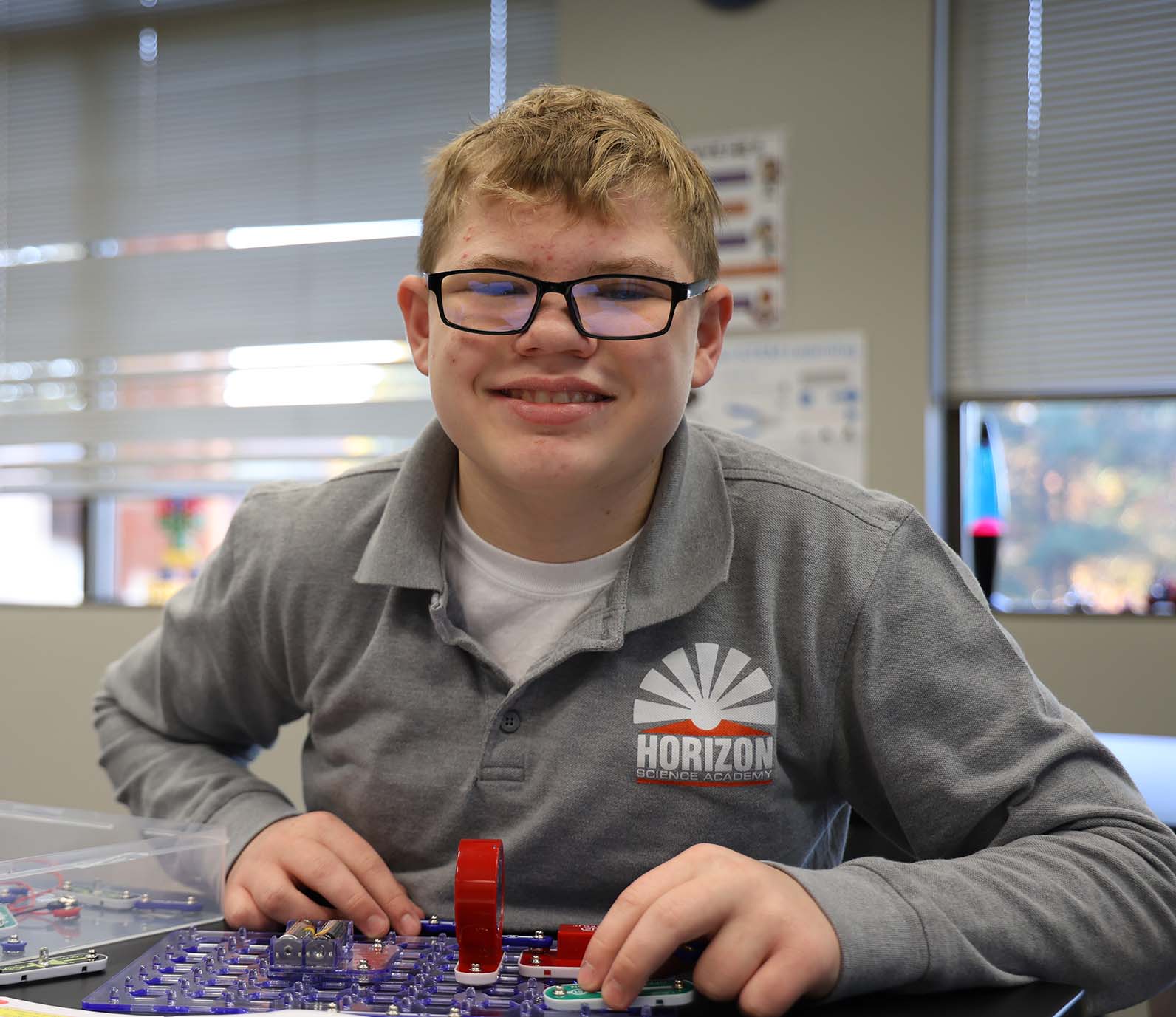 HSA Westerville student wearing headphones uses a laptop in class
